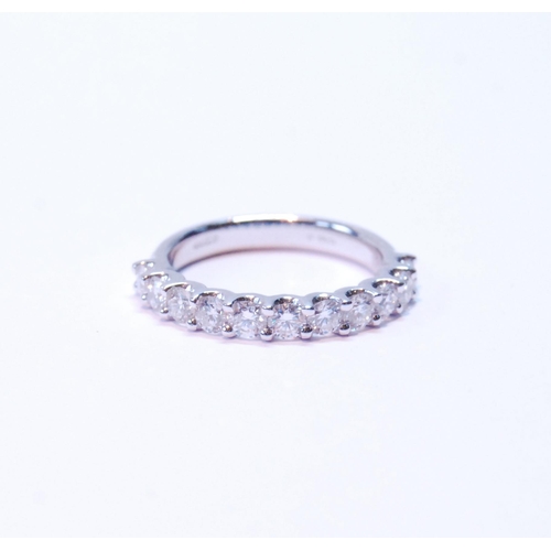 90 - Diamond half eternity ring with eleven brilliants, each approximately .10ct, in platinum, size M.