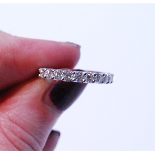 90 - Diamond half eternity ring with eleven brilliants, each approximately .10ct, in platinum, size M.