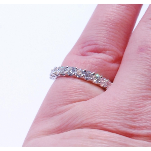 90 - Diamond half eternity ring with eleven brilliants, each approximately .10ct, in platinum, size M.