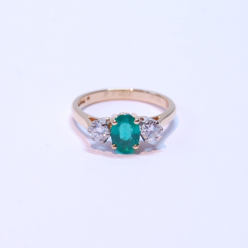 91 - Diamond and emerald three-stone ring, the oval emerald approximately .72mm x 5mm, between two brilli... 