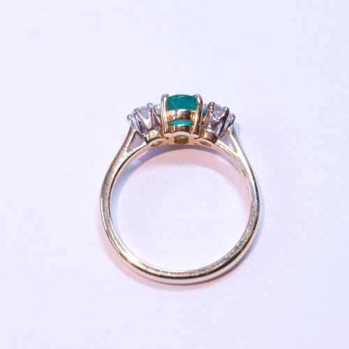 91 - Diamond and emerald three-stone ring, the oval emerald approximately .72mm x 5mm, between two brilli... 