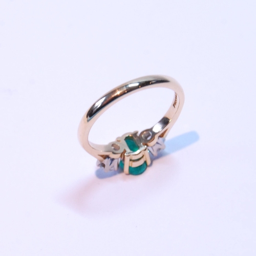 91 - Diamond and emerald three-stone ring, the oval emerald approximately .72mm x 5mm, between two brilli... 