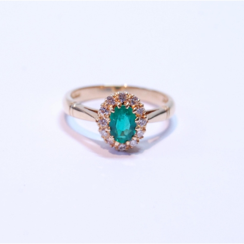 92 - Diamond and emerald oval cluster ring, the emerald approximately 5mm x 4mm, and small diamond brilli... 