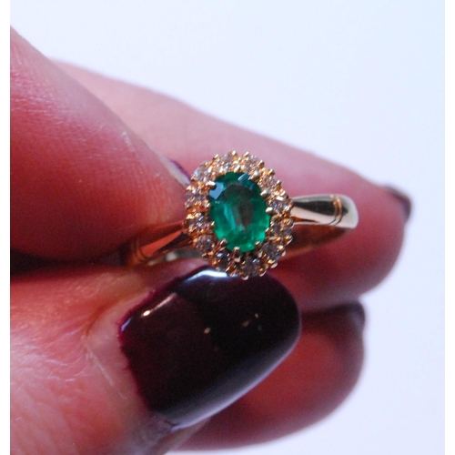 92 - Diamond and emerald oval cluster ring, the emerald approximately 5mm x 4mm, and small diamond brilli... 