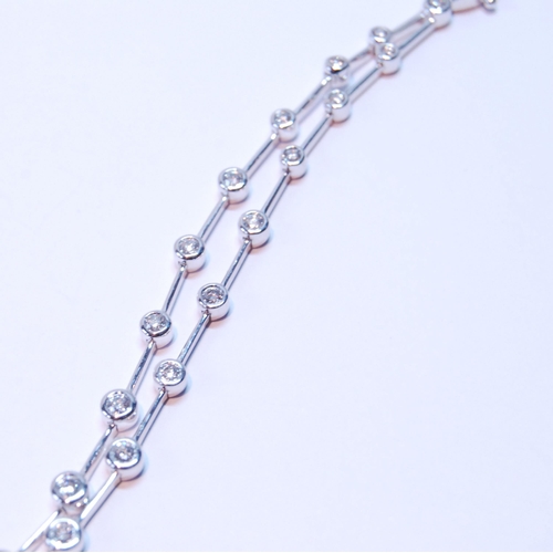 93 - Bracelet with a double row of diamond brilliants, collet-set, thirty-six in all, in 18ct white gold.