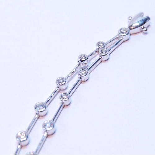 93 - Bracelet with a double row of diamond brilliants, collet-set, thirty-six in all, in 18ct white gold.