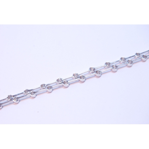 93 - Bracelet with a double row of diamond brilliants, collet-set, thirty-six in all, in 18ct white gold.