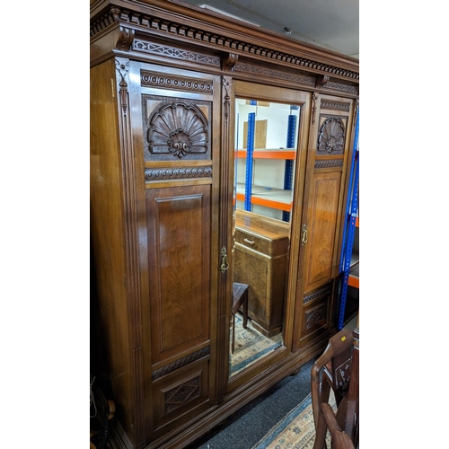 477 - John Taylor & Son of Edinburgh three door wardrobe, with moulded and dentil cornice over shell a... 