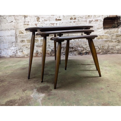 482 - Set of three Ercol dark elm top pebble nesting tables, largest measures 40cm high.