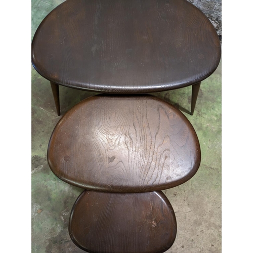 482 - Set of three Ercol dark elm top pebble nesting tables, largest measures 40cm high.