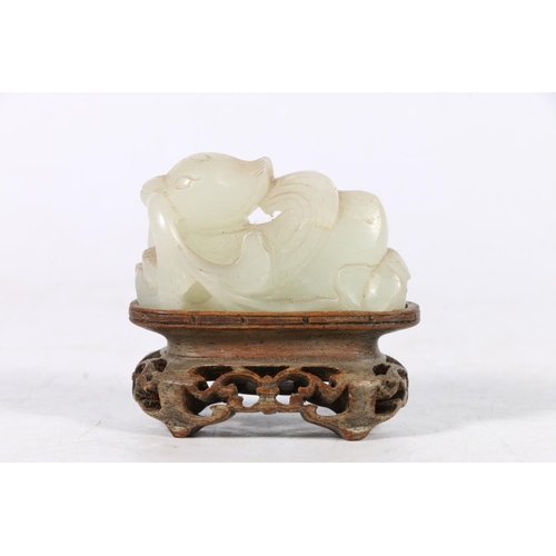 395 - Chinese jade carving of a mythical creature, unsigned, 5cm long, raised on carved and pierced hardwo... 