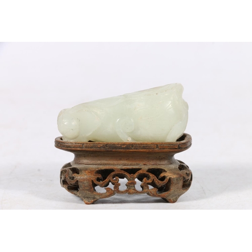395 - Chinese jade carving of a mythical creature, unsigned, 5cm long, raised on carved and pierced hardwo... 