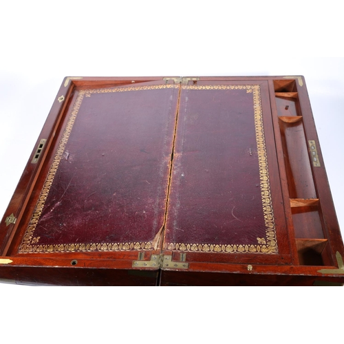 266 - Victorian mahogany campaign style writing slope, the hinged top enclosing a tooled interior, with br... 