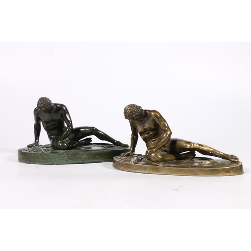 287 - Two 20th century bronze castings of a fallen Roman soldier, modelled sat upon his Gladius type sword... 