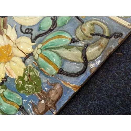 307 - Large Italian relief pottery tile decorated with flowers, 45cmx 54cm.