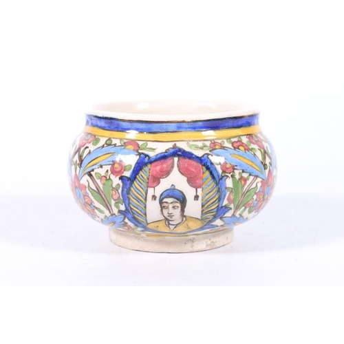 309 - Persian Qajar period pottery bowl decorated in the typical style with vignettes of male figures agai... 