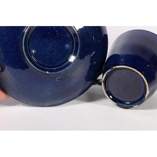 319 - Scottish Pottery, a Dunmore pottery blue glazed tetsubin style teapot and matching cup and saucer. (... 