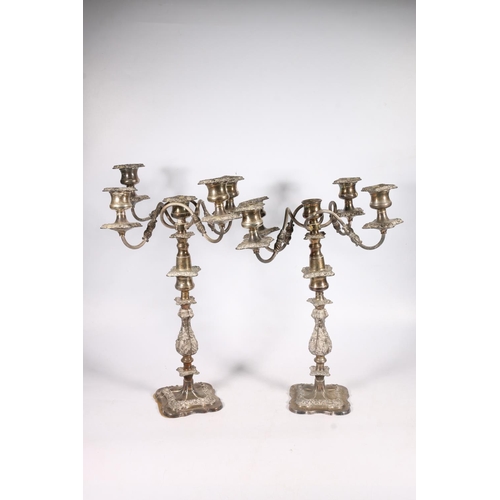 71 - Pair of silver plated four branch, five light candelabra with scroll arms and relief foliate decorat... 