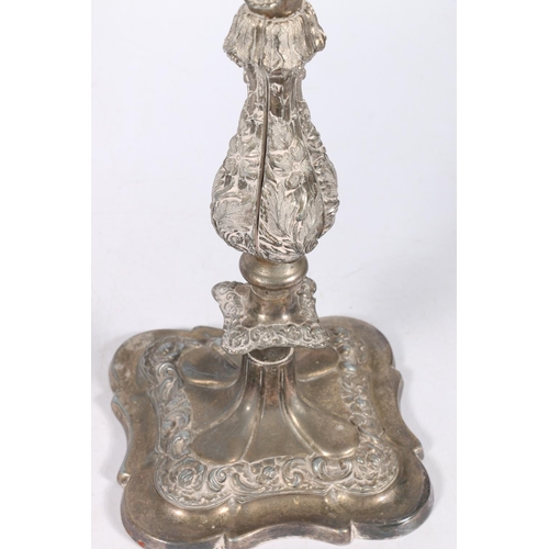 71 - Pair of silver plated four branch, five light candelabra with scroll arms and relief foliate decorat... 