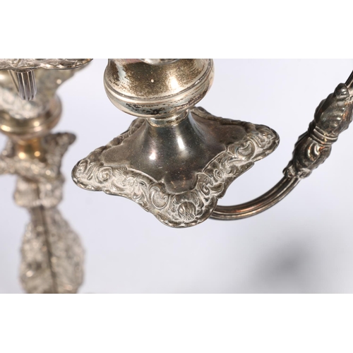 71 - Pair of silver plated four branch, five light candelabra with scroll arms and relief foliate decorat... 