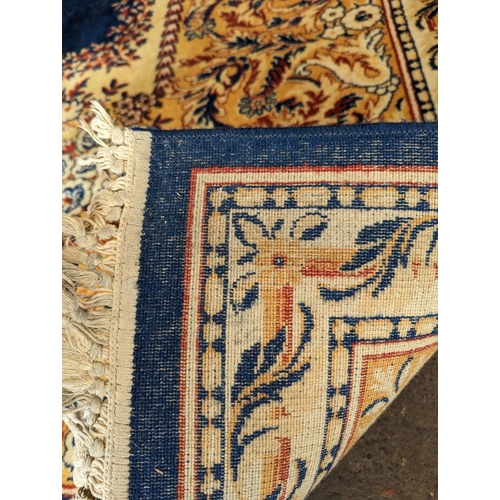 486 - Prado Oriental Keshan carpet with floral decorated central medallion on blue field within foliate bo... 