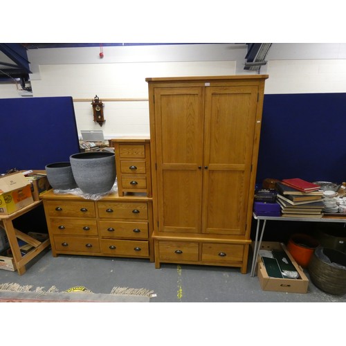 446 - Modern oak furniture suite comprising of a wardrobe, sideboard and bedside cabinet. (3)