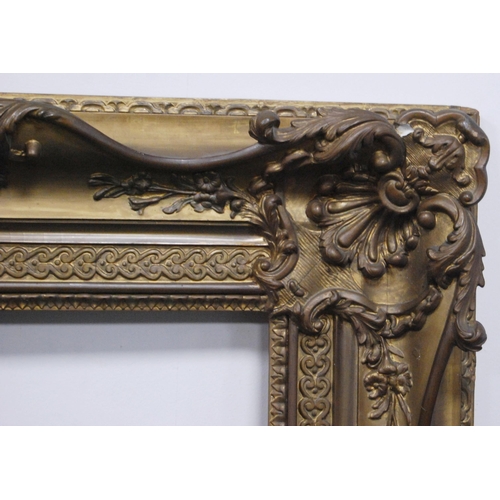 212 - 19th century giltwood and gesso French-style picture frame decorated with scroll cartouche, aperture... 