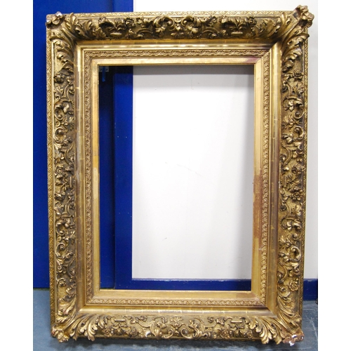 213 - 19th century ornate giltwood and gesso picture frame decorated all over with acanthus scrolls, apert... 