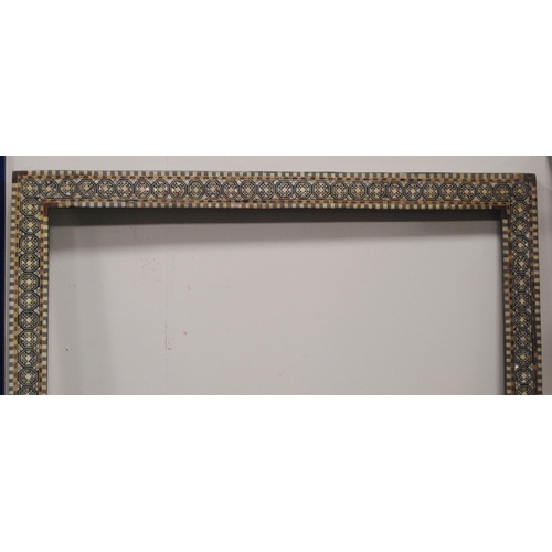 215 - Two near-matching antique Indo-Persian picture frames profusely inlaid with mother of pearl and bone... 