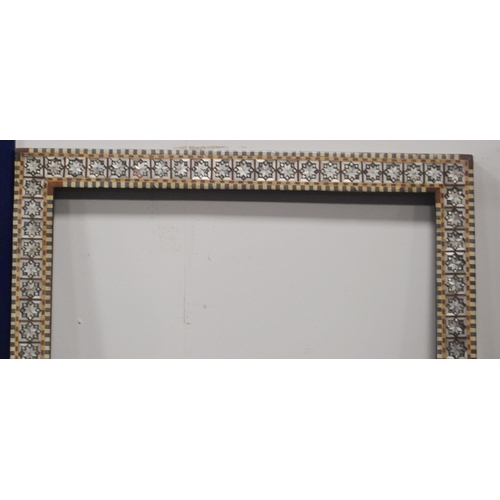 215 - Two near-matching antique Indo-Persian picture frames profusely inlaid with mother of pearl and bone... 