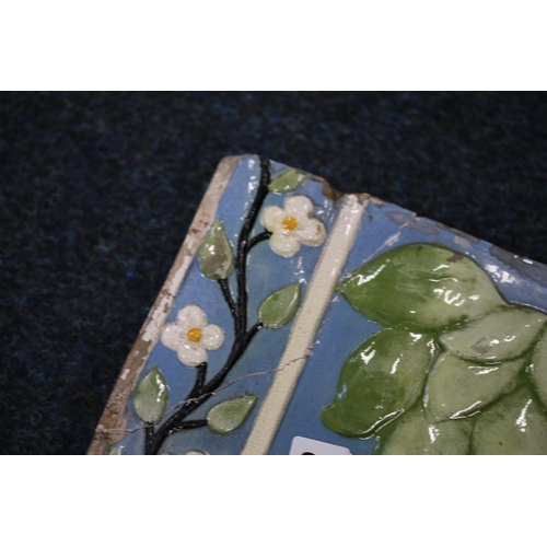 307 - Large Italian relief pottery tile decorated with flowers, 45cmx 54cm.