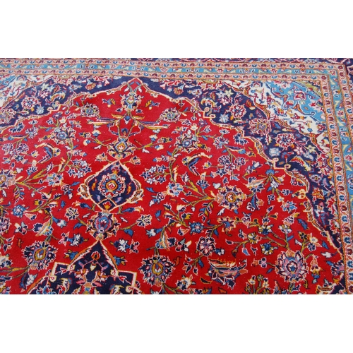 364 - Persian Tabriz carpet with a large medallion to the centre, all over foliate swags to the border, on... 