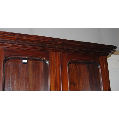 419 - Victorian-style mahogany four-door library bookcase, the dentil decorated cornice above four glazed ... 