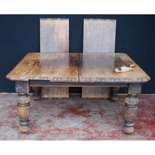 422 - Oak extending dining table, c. early 20th century, with two additional leaves, with incised decorati... 