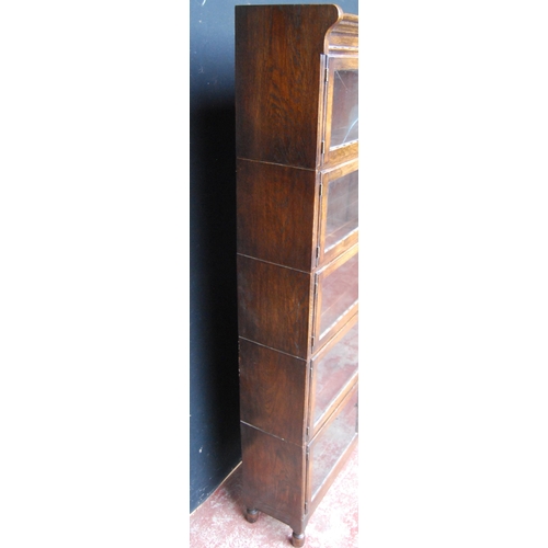 423 - Oak bookcase with two glazed doors to each section, 161cm high, 89cm wide and 26cm deep.