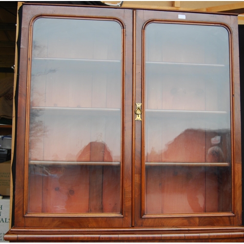 424 - Victorian mahogany library bookcase on cylinder bureau base, the bookcase section with two glazed do... 