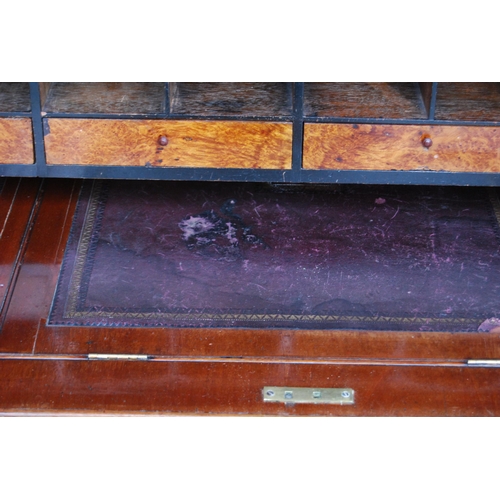 424 - Victorian mahogany library bookcase on cylinder bureau base, the bookcase section with two glazed do... 