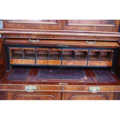 424 - Victorian mahogany library bookcase on cylinder bureau base, the bookcase section with two glazed do... 