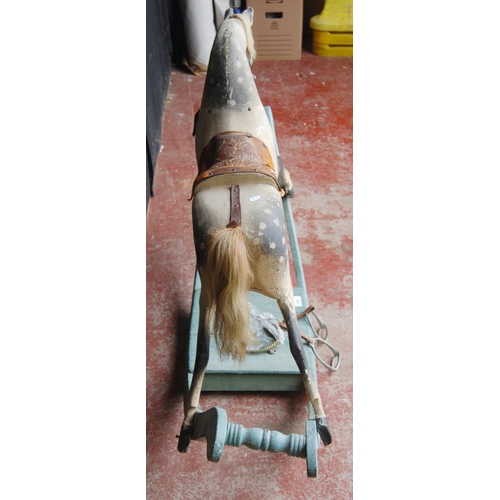 224 - Vintage painted wood dapple grey rocking horse fixed to a painted cradle, with loose stirrups, 91cm ... 