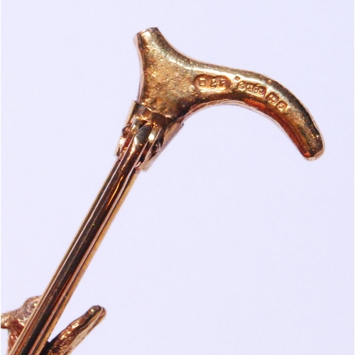 126 - 9ct gold hunting brooch modelled as a fox on a riding crop, stamped '375', 5g gross.