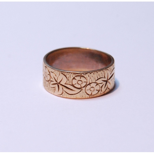 131 - 18ct gold band with all over foliate decoration, stamped '750', size N/O, 5.7g.