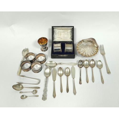 3 - Silver butter shell, six napkin rings, a baluster caster and various items of flatware.