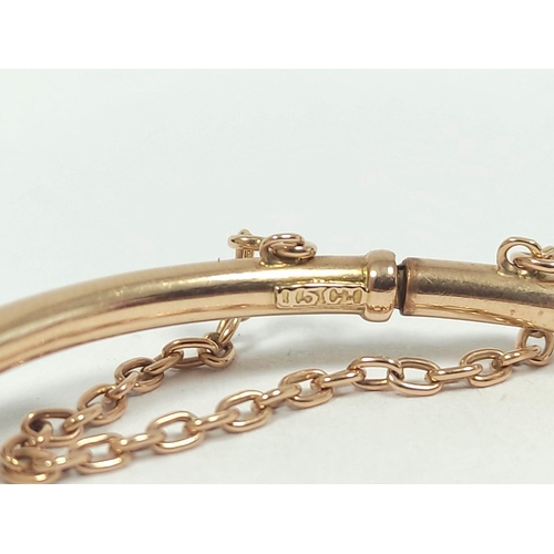54 - Edwardian gold hinged tubular bangle with diamond set horseshoe and collets '15ct'