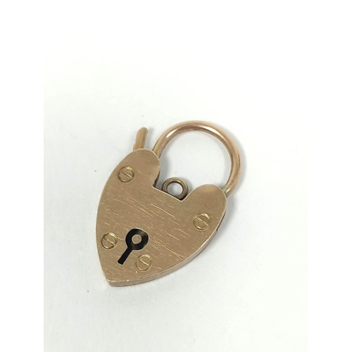 76 - 9ct gold padlock and two charms. 7g