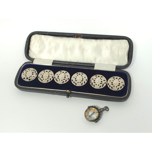 78 - Set of six silver pierced buttons by Liberty 1900, cased, and a silver compass.