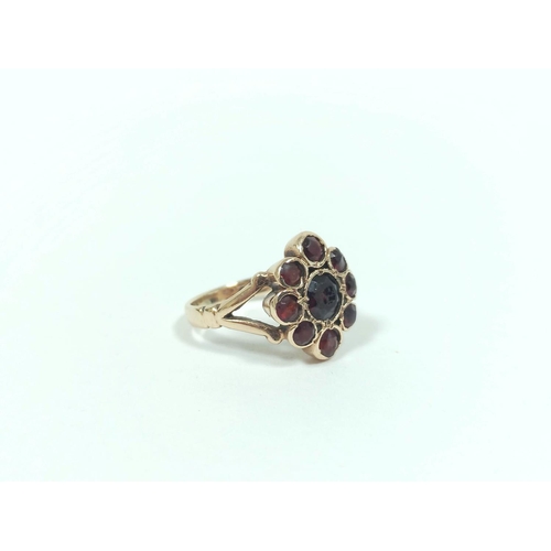 81 - 9ct gold garnet cluster ring 5.8g. Size 'J'.