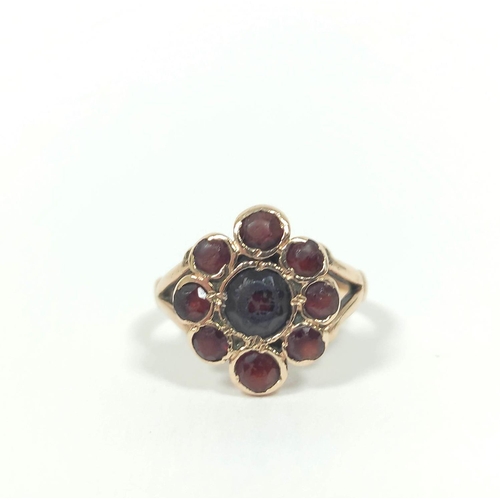 81 - 9ct gold garnet cluster ring 5.8g. Size 'J'.