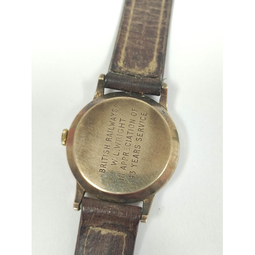 82 - Smiths de Luxe 9ct gold watch inscribed and dated 'British Railways W L Wright' on strap 1962. 31mm.