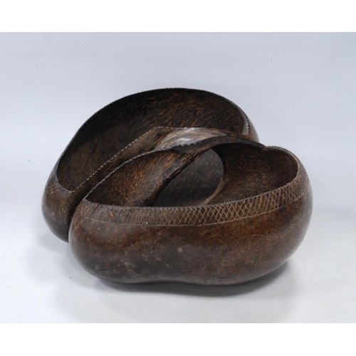 221 - Coco de Mer nut carved in the form of a basket, origin Seychelles, 11cm high and approximately 32cm ... 