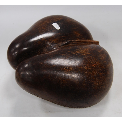 221 - Coco de Mer nut carved in the form of a basket, origin Seychelles, 11cm high and approximately 32cm ... 